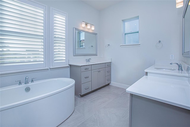 bathroom with vanity, tile patterned floors, and a bathing tub