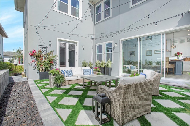 view of patio / terrace with french doors and an outdoor living space