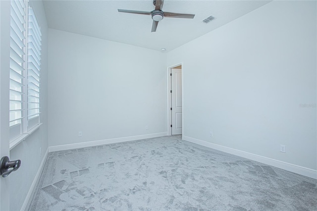 spare room featuring carpet floors and ceiling fan