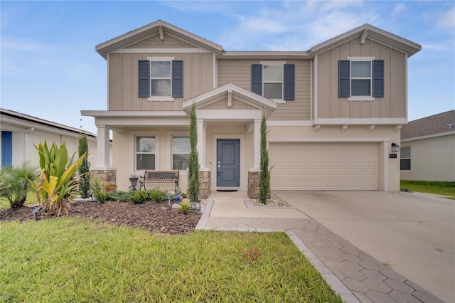 craftsman inspired home with a garage, a porch, and a front lawn