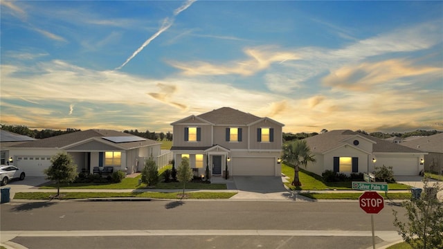 view of front facade featuring a yard and a garage