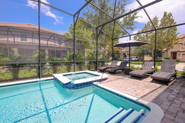 view of pool with a patio, glass enclosure, and an in ground hot tub