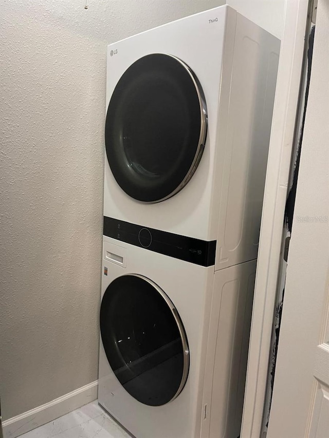 laundry room with stacked washer and dryer