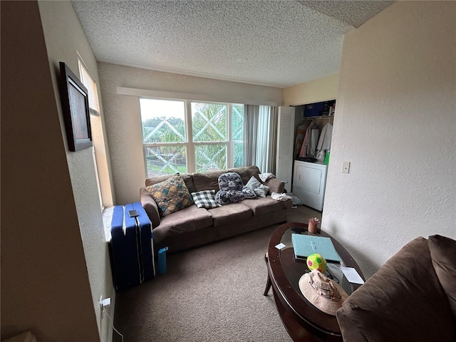 living room with carpet floors, a textured ceiling, washer / clothes dryer, and a textured wall