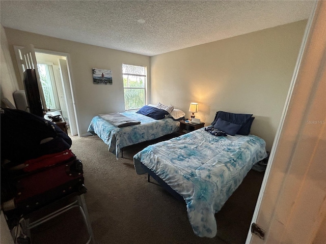 bedroom featuring carpet and a textured ceiling