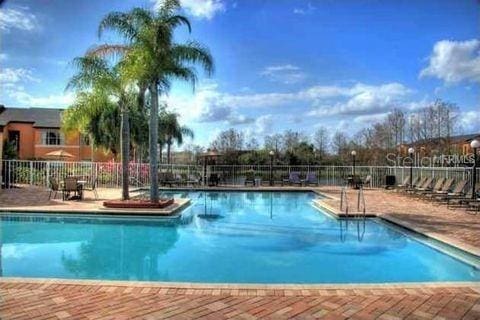 pool featuring a patio area and fence