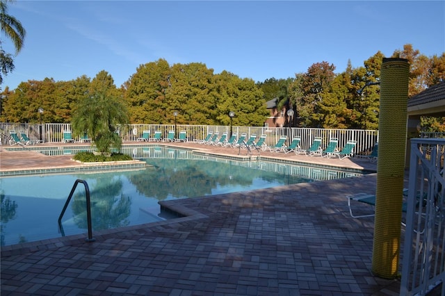 pool featuring a patio and fence