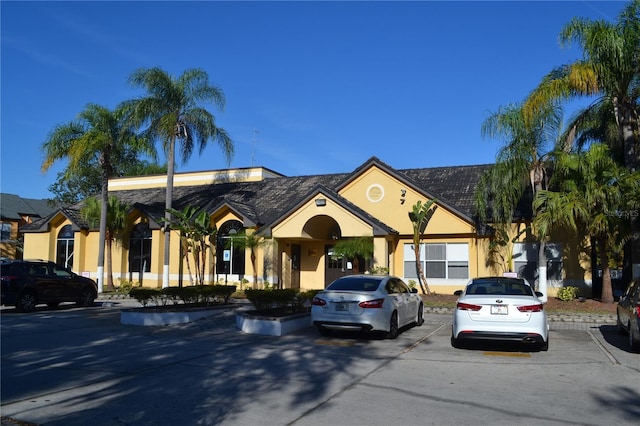 view of front of home featuring stucco siding and uncovered parking