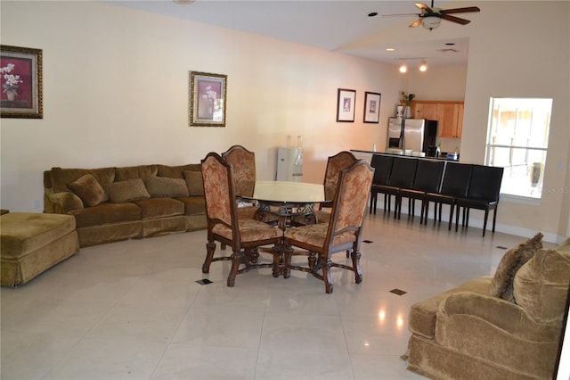 dining area with light tile patterned floors, baseboards, and ceiling fan