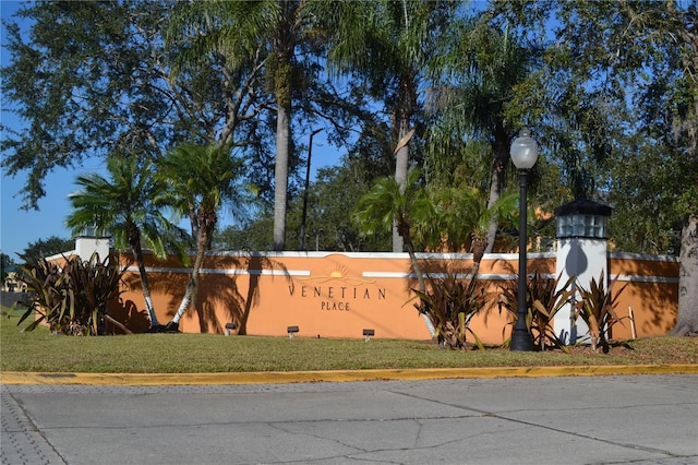 community sign featuring a lawn