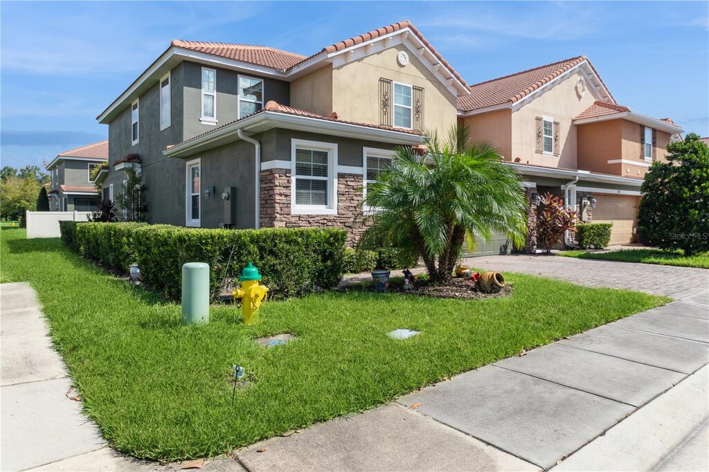 view of front of property featuring a garage and a front lawn