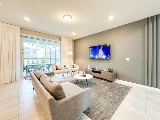 living room featuring recessed lighting, a textured ceiling, baseboards, and light tile patterned floors