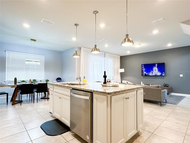 kitchen featuring light stone countertops, dishwasher, a wealth of natural light, and hanging light fixtures