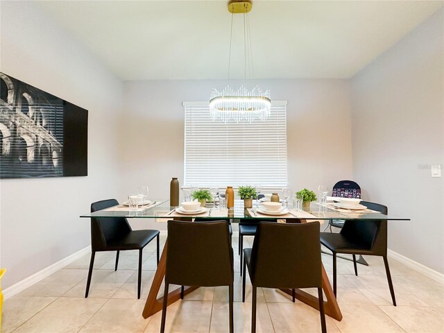 dining area featuring a notable chandelier and light tile patterned flooring