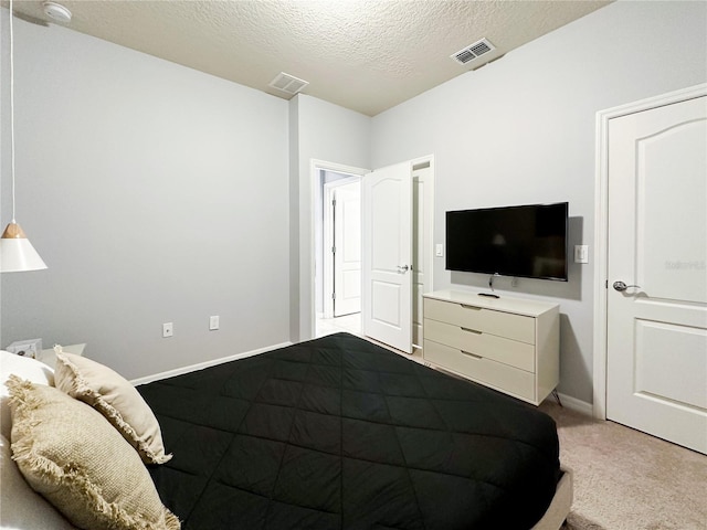 carpeted bedroom with a textured ceiling