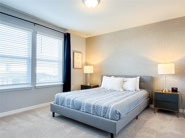 bedroom featuring carpet, baseboards, and wallpapered walls