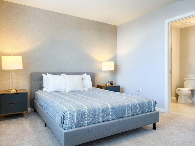 bedroom featuring light carpet, ensuite bath, baseboards, and wallpapered walls