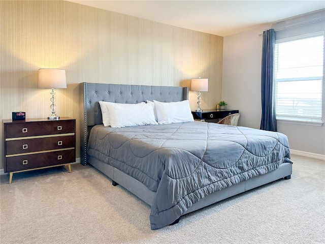 bedroom featuring carpet, baseboards, and wallpapered walls