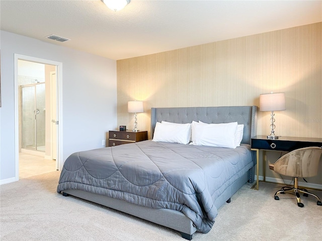 carpeted bedroom featuring wallpapered walls, connected bathroom, visible vents, and baseboards