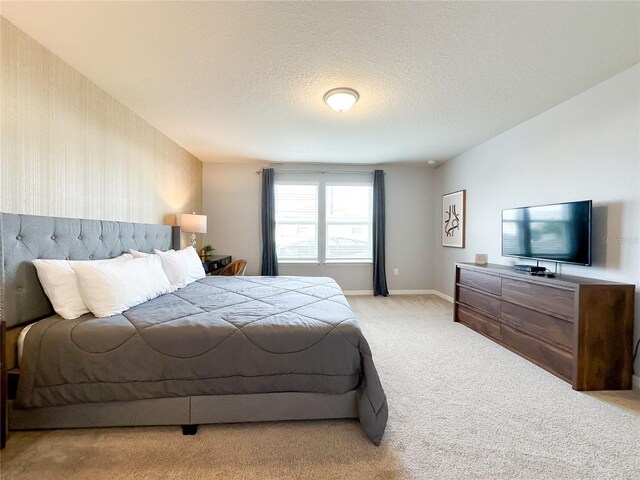 carpeted bedroom featuring a textured ceiling