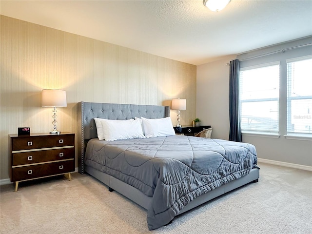 bedroom featuring a textured ceiling, carpet floors, and baseboards