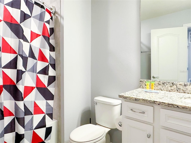 bathroom featuring vanity, toilet, and curtained shower