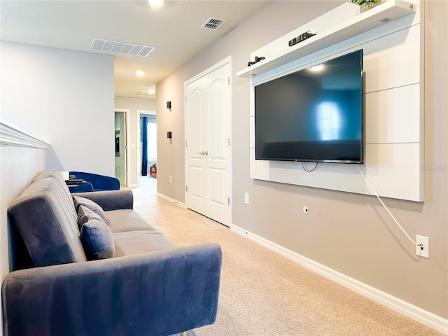 living area with carpet, visible vents, and baseboards