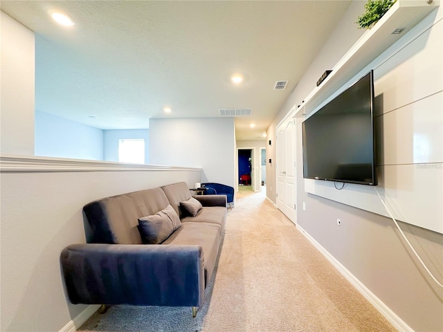 carpeted living area featuring recessed lighting, visible vents, and baseboards