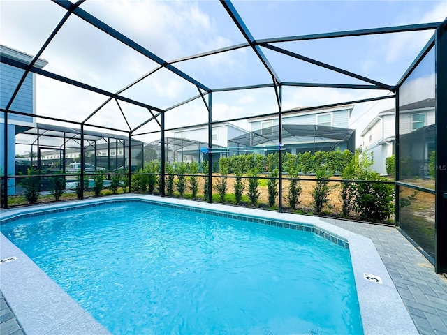 outdoor pool with a lanai and a patio area