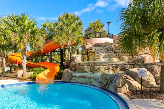 community pool featuring a water slide