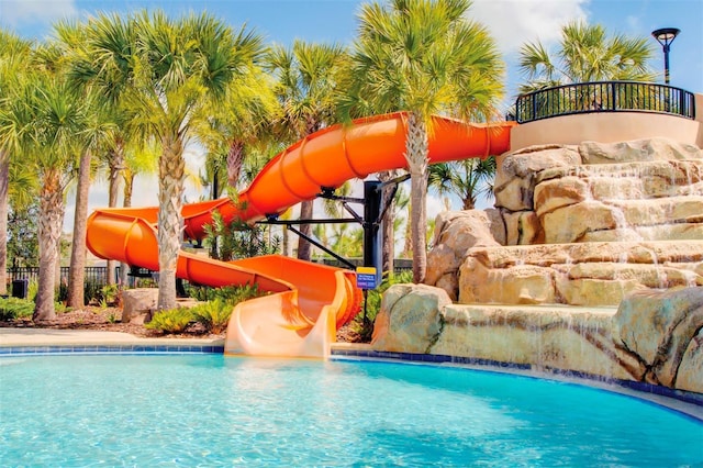 pool featuring fence and a water slide