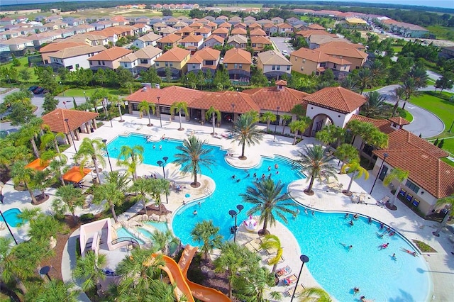 view of swimming pool with a patio and a residential view