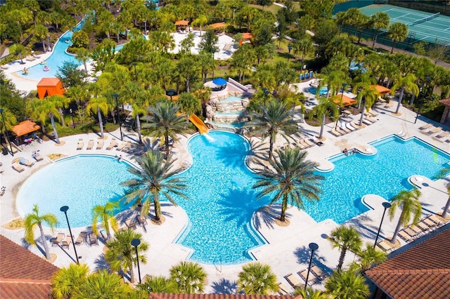 view of swimming pool with a water slide and a patio area