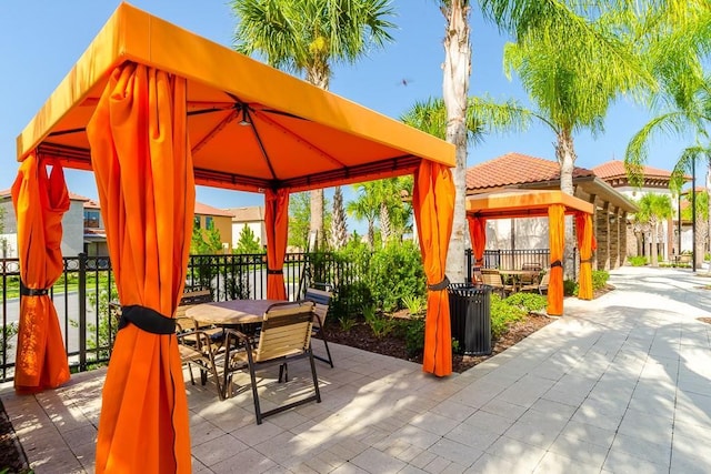 view of patio featuring outdoor dining area and a gazebo