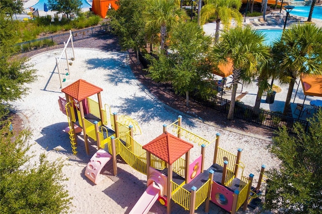 community playground with a community pool and fence