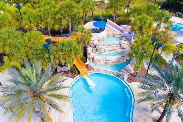 pool with a community hot tub and a water slide