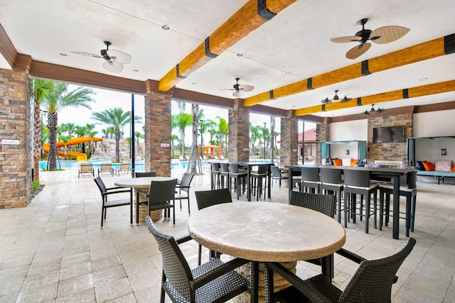 view of patio featuring a bar and ceiling fan