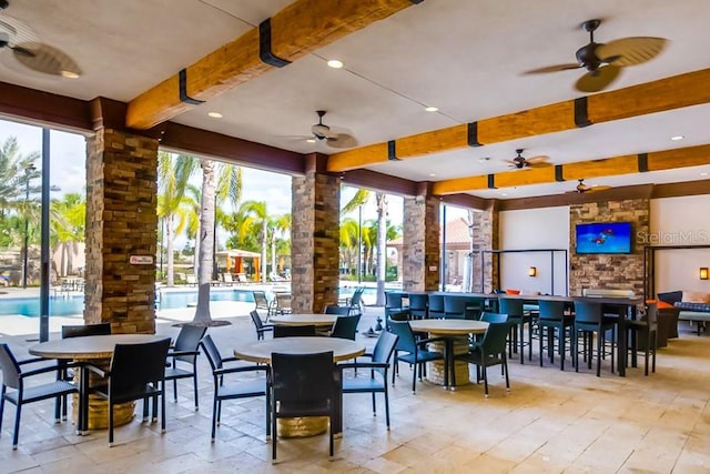 interior space featuring ceiling fan and a community pool