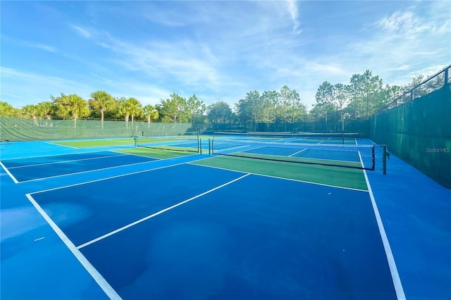 view of tennis court with fence