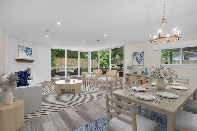 dining space featuring hardwood / wood-style floors and a chandelier