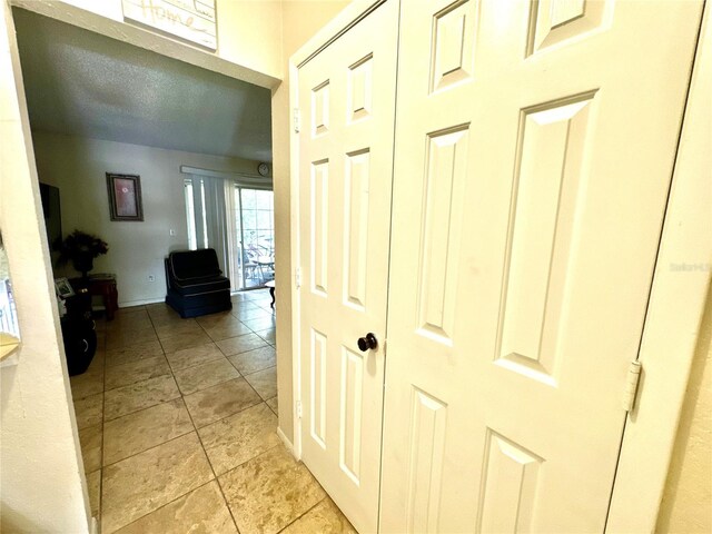 corridor featuring light tile patterned flooring