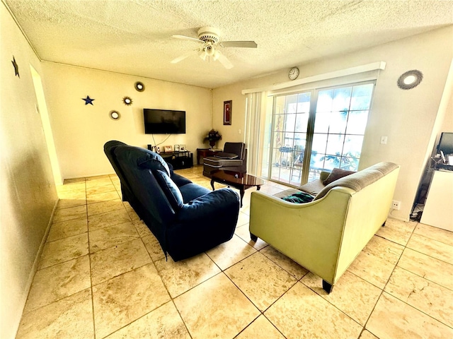 tiled living room featuring a textured ceiling and ceiling fan