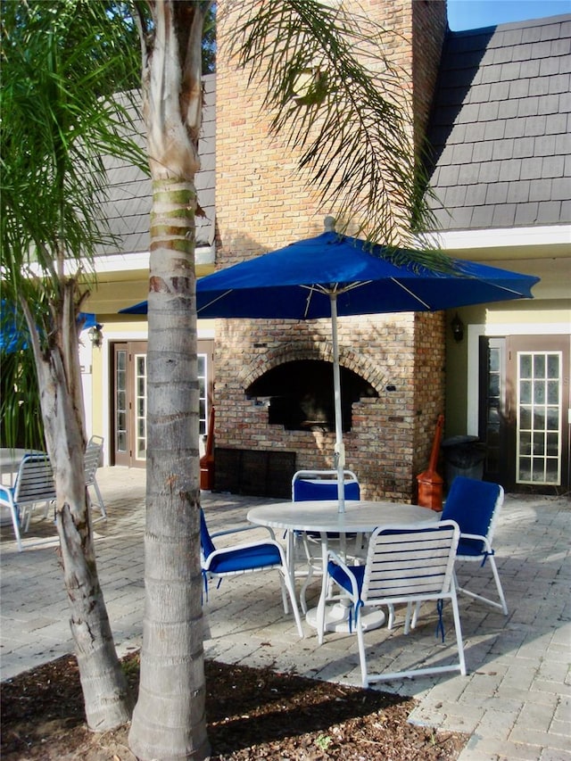 view of patio / terrace with exterior fireplace and french doors