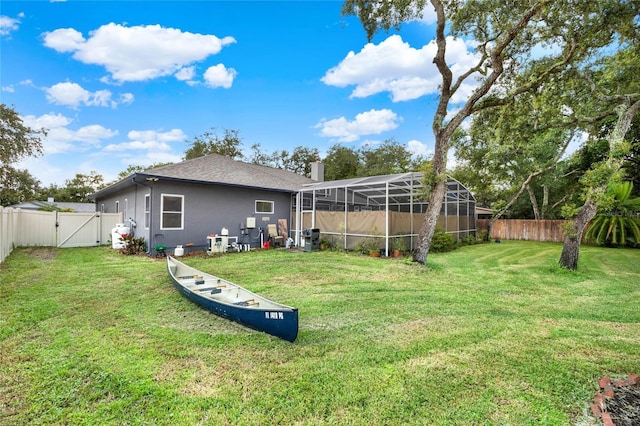 view of yard featuring glass enclosure