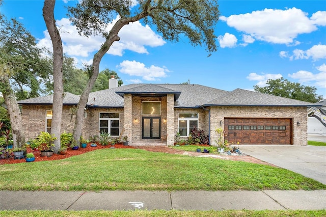 prairie-style home with a garage and a front lawn