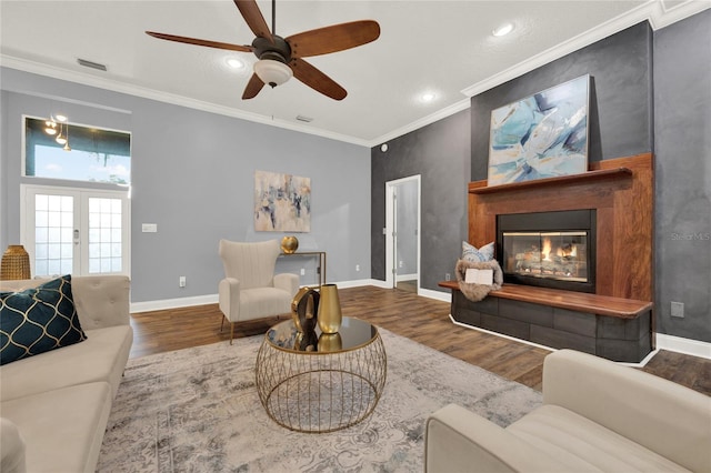 living room featuring crown molding, french doors, ceiling fan, and hardwood / wood-style flooring