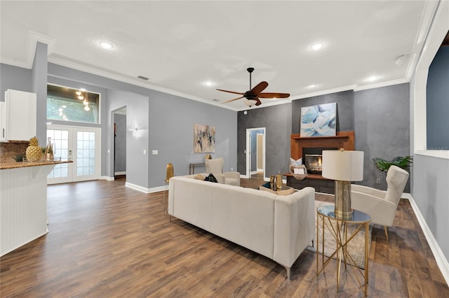 living room featuring crown molding, dark hardwood / wood-style floors, ceiling fan, and french doors