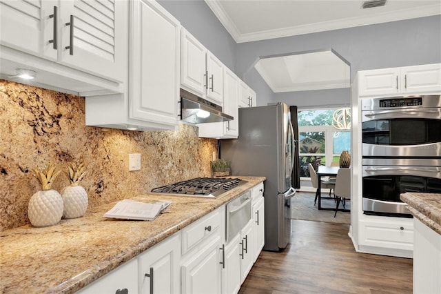 kitchen featuring white cabinetry, light stone counters, ornamental molding, and stainless steel appliances