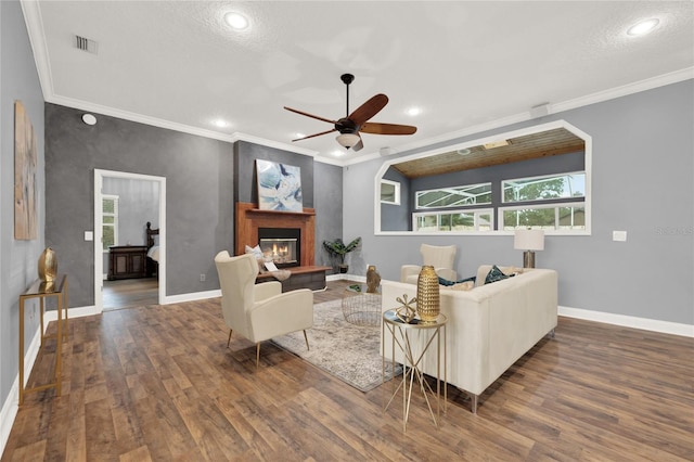 living room with ornamental molding, dark hardwood / wood-style floors, and ceiling fan