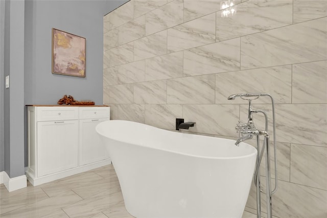 bathroom featuring tile walls and a washtub